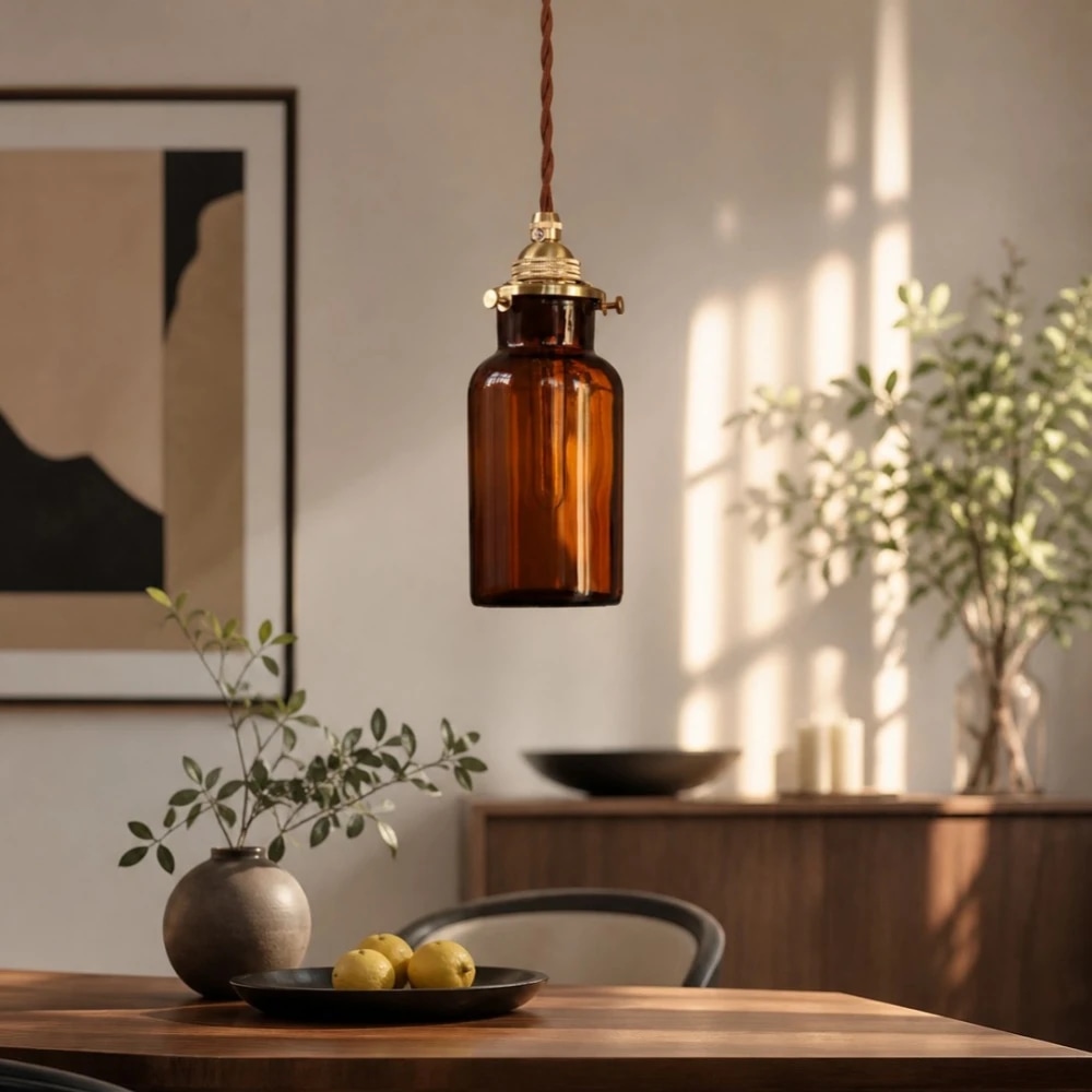 Amber brown pendant lamp above dining space