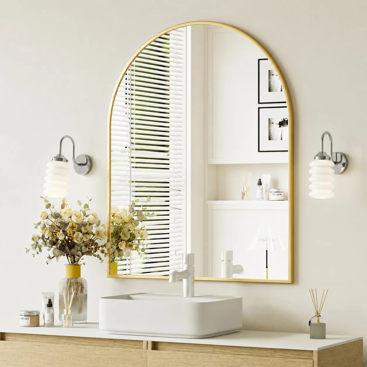 Chrome ribbed glass wall sconces framing an arched vanity mirror