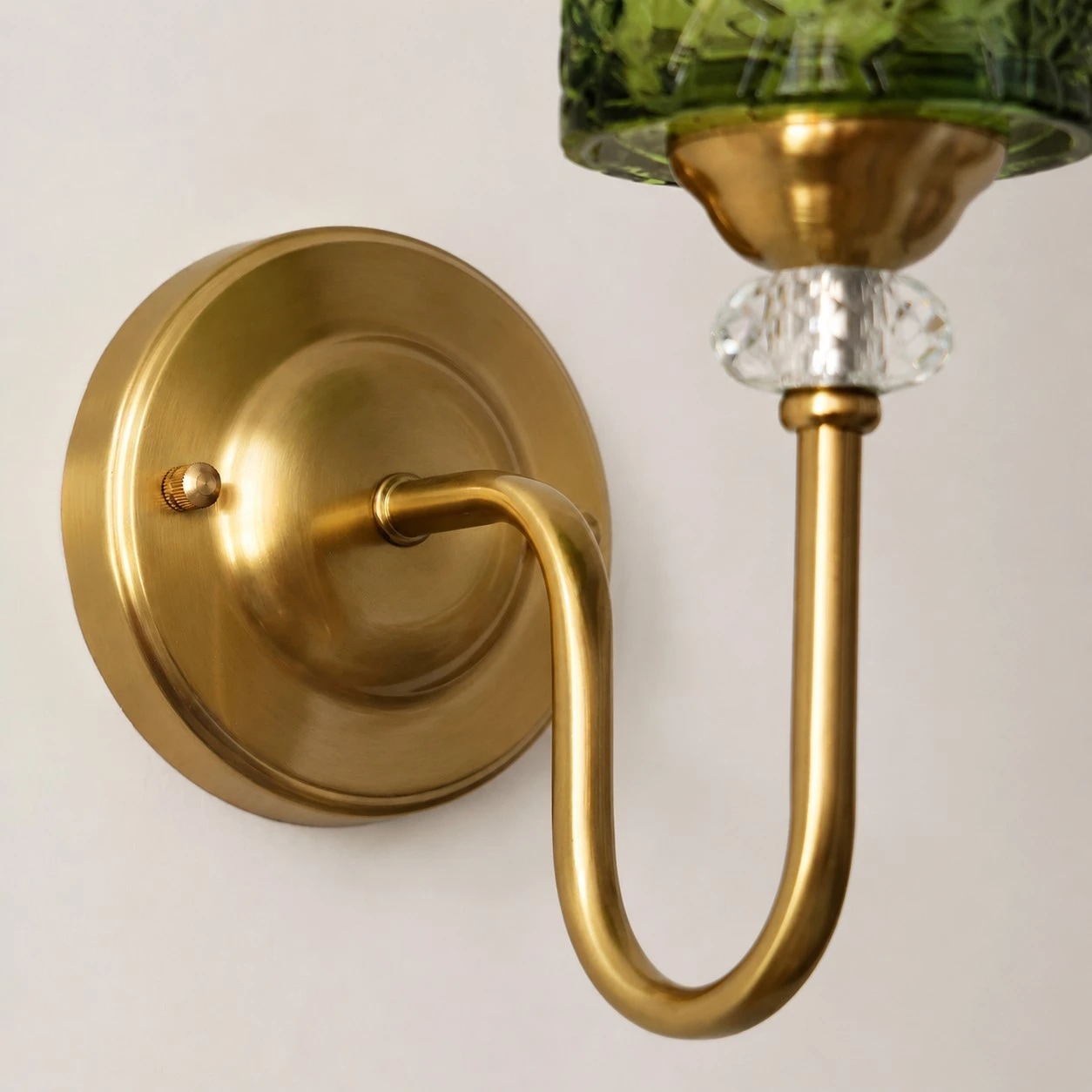 Brass tone backplate and curved arm detail