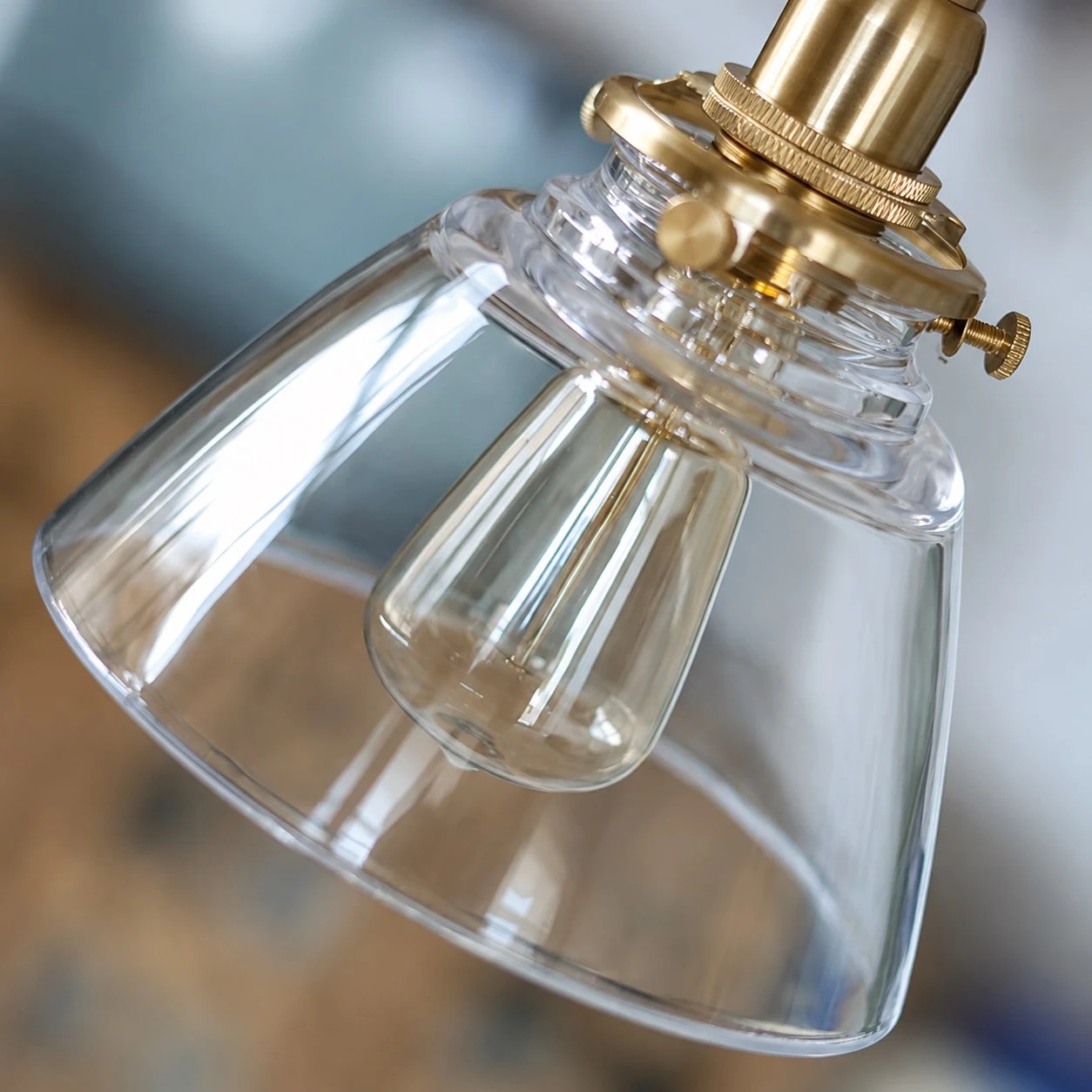 Clear glass shade and brass lamp holder detail