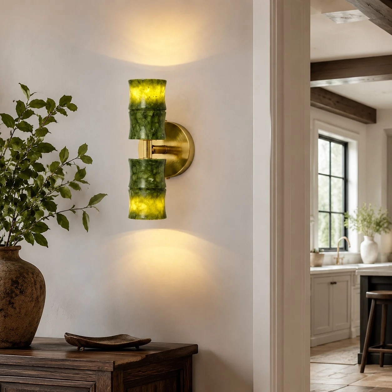 A sculptural green bamboo-form wall lamp with a warm brass-tone backplate.