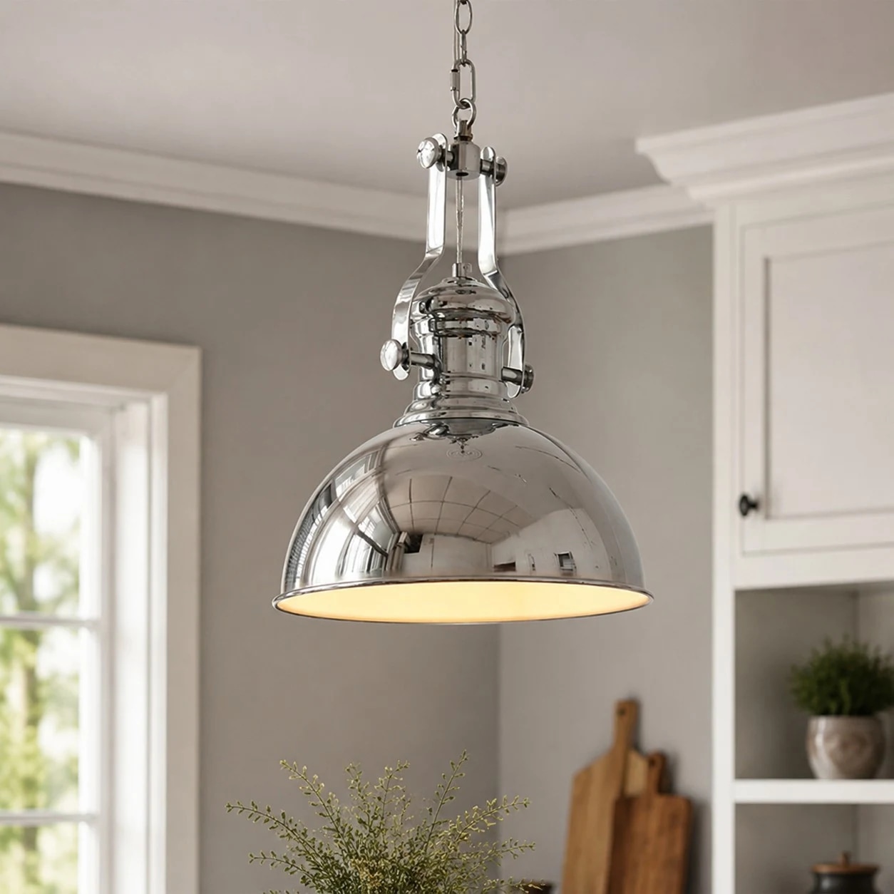 Chrome pendant light installed in a dining room