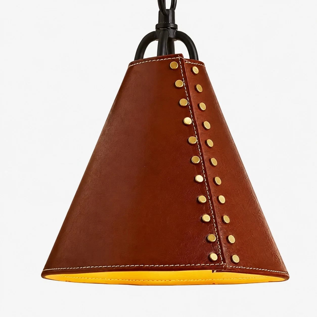 Close view of red leather shade with gold rivets