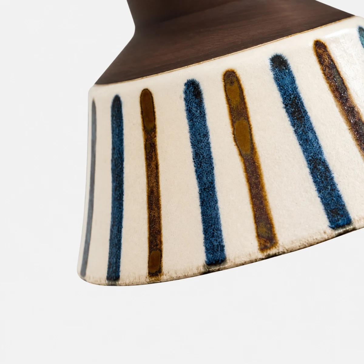 Close view of striped hand-painted ceramic glaze
