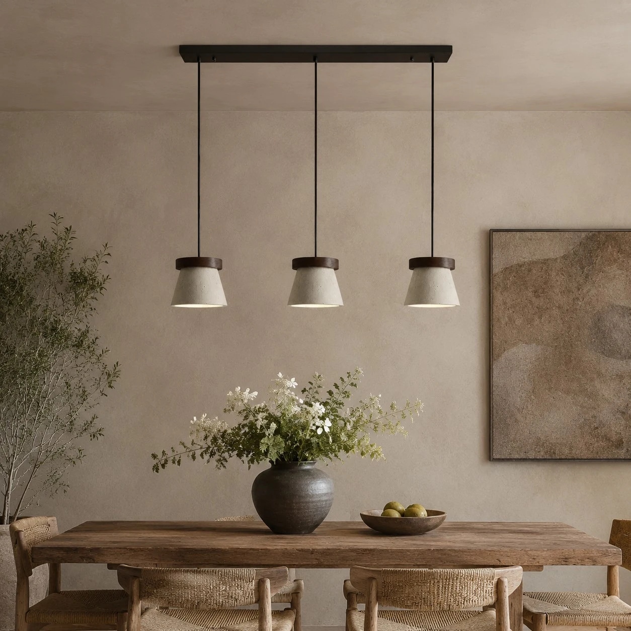 Three-light pendant installed over a dining table