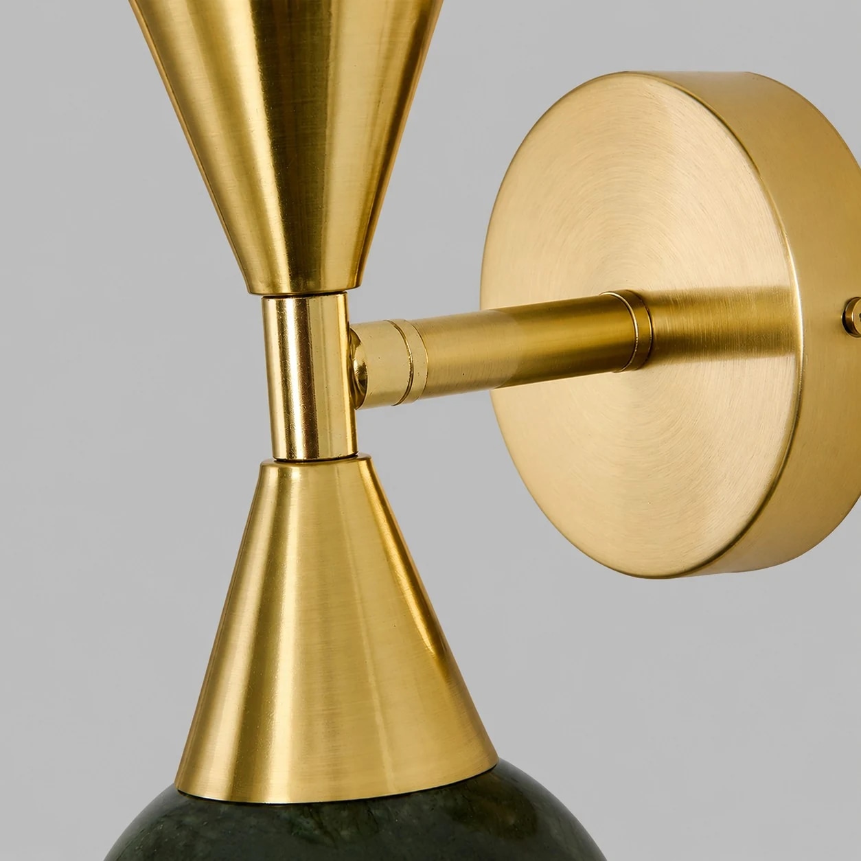 Brushed gold round wall plate and lamp arm detail
