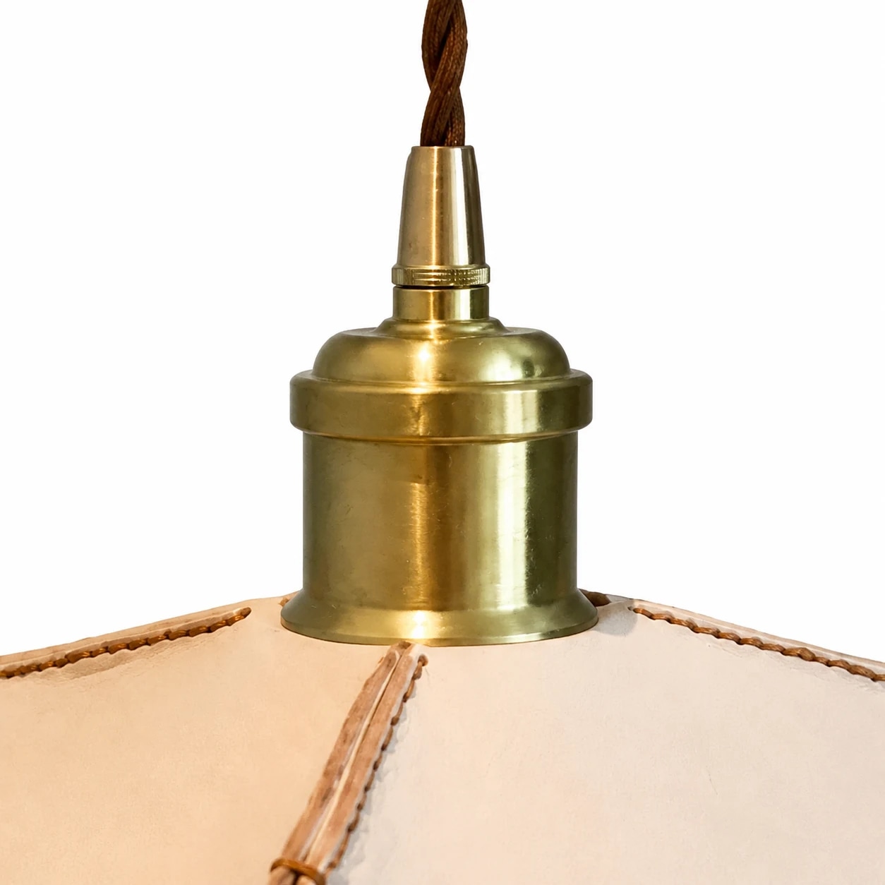 Close-up of brass-tone metal pendant socket and leather shade top