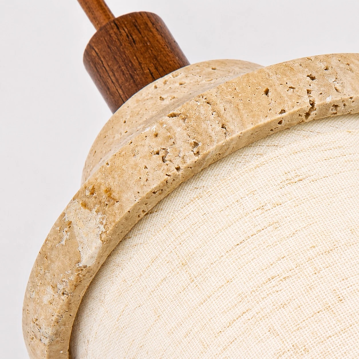 Travertine-like stone rim and pitted texture close-up