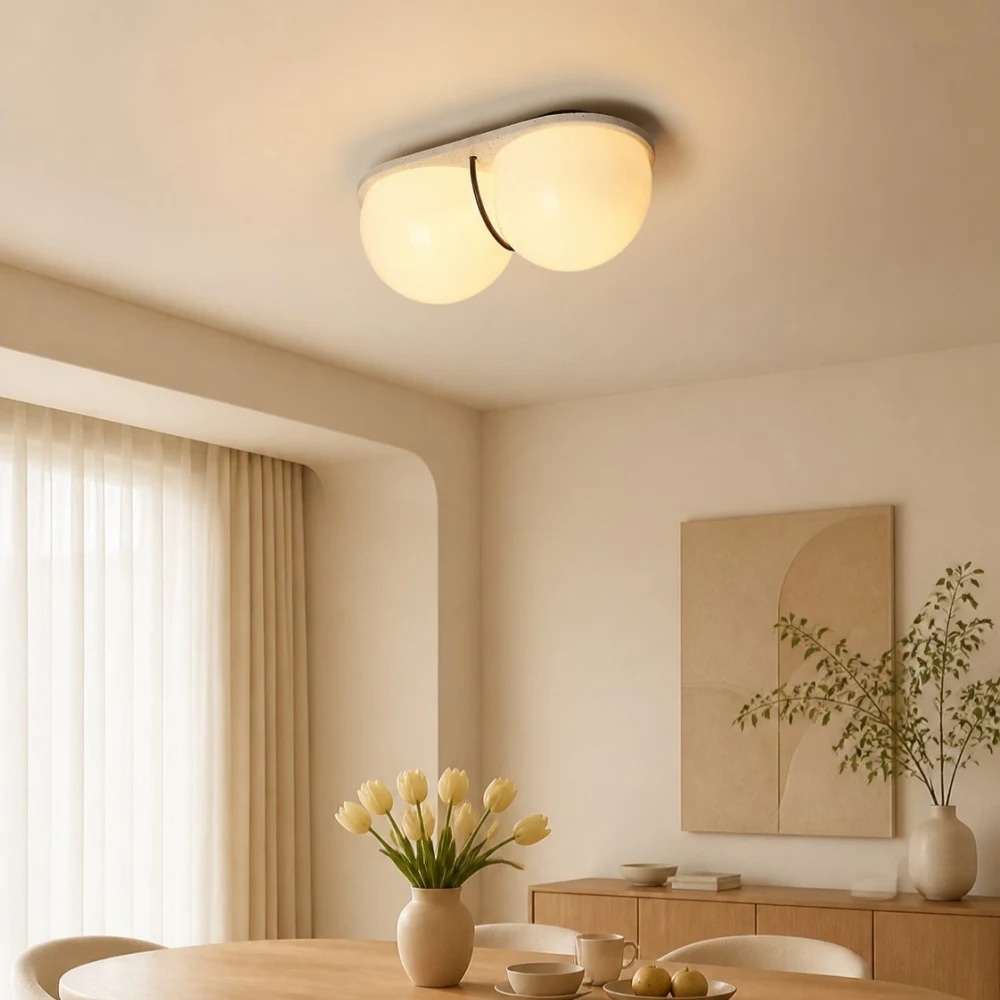 Cream travertine ceiling lamp above a dining space