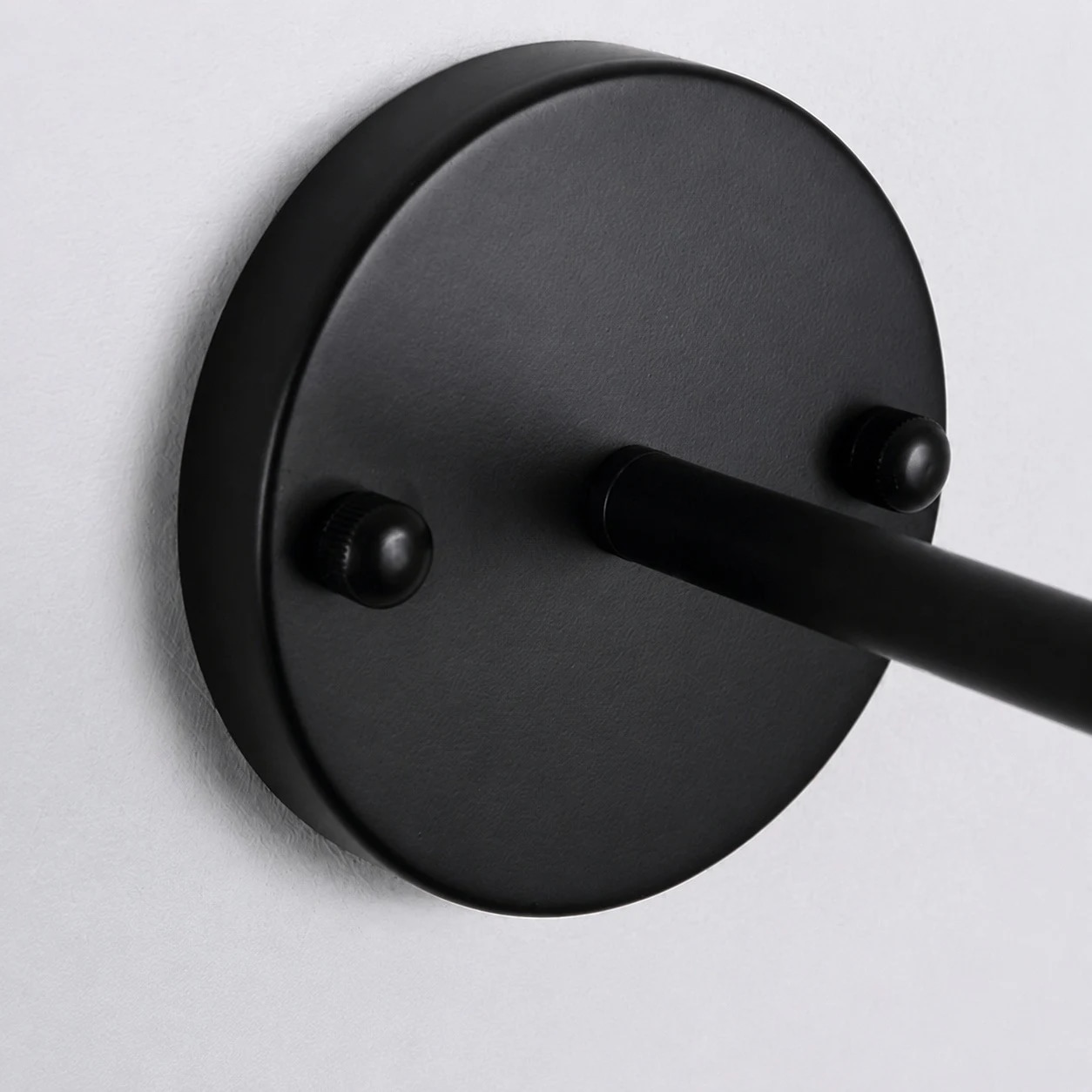 Round black canopy mounted to the wall