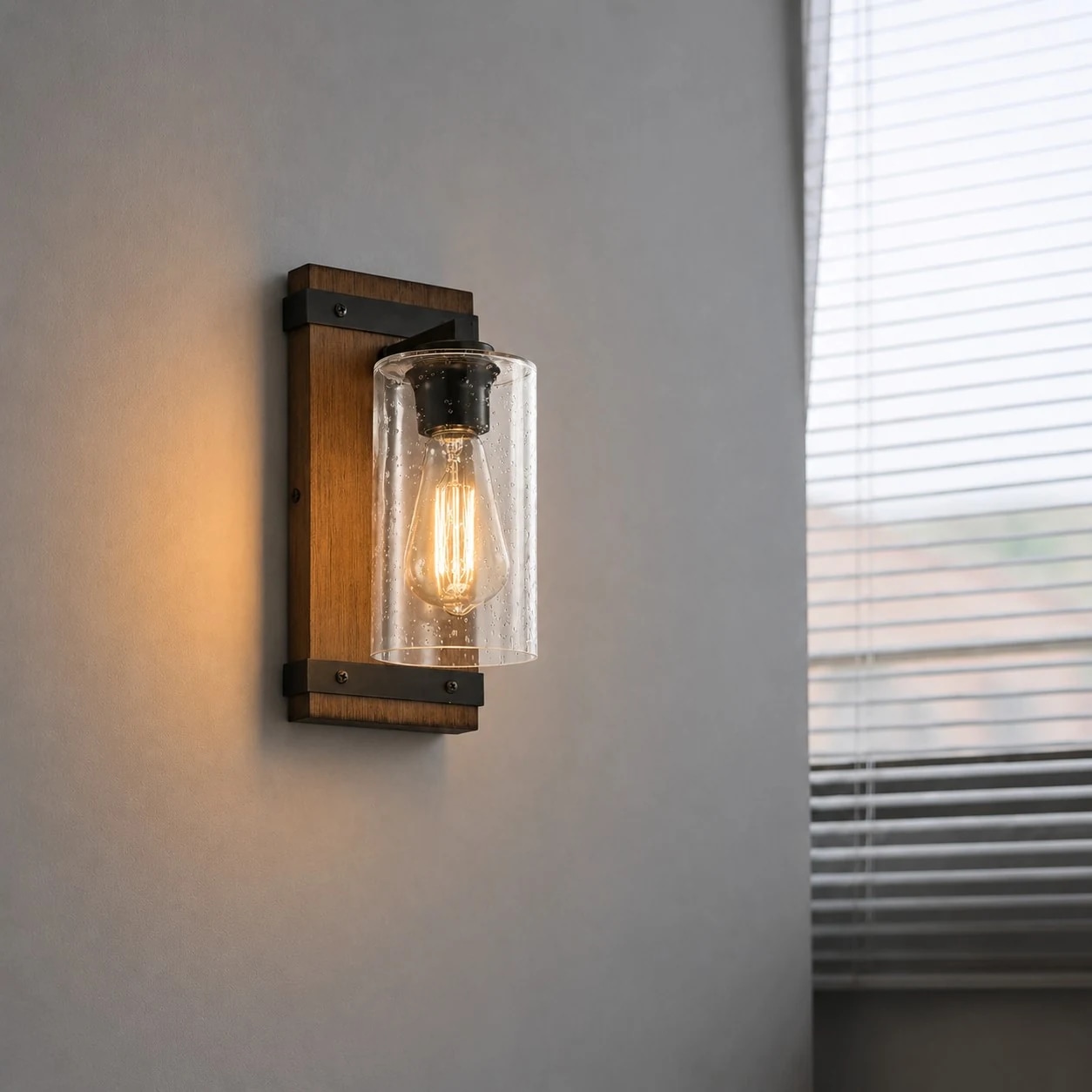 Vintage industrial glass wall sconce with wood color backplate and seeded clear glass shade