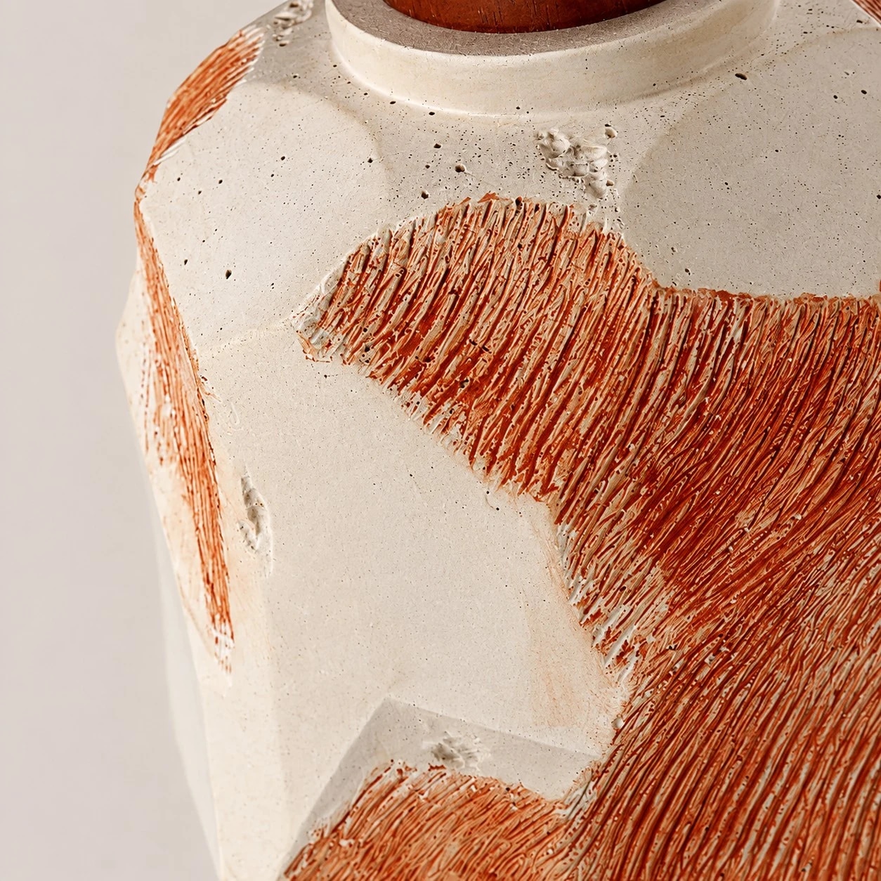 Close-up of microcement texture and raised terracotta ridges