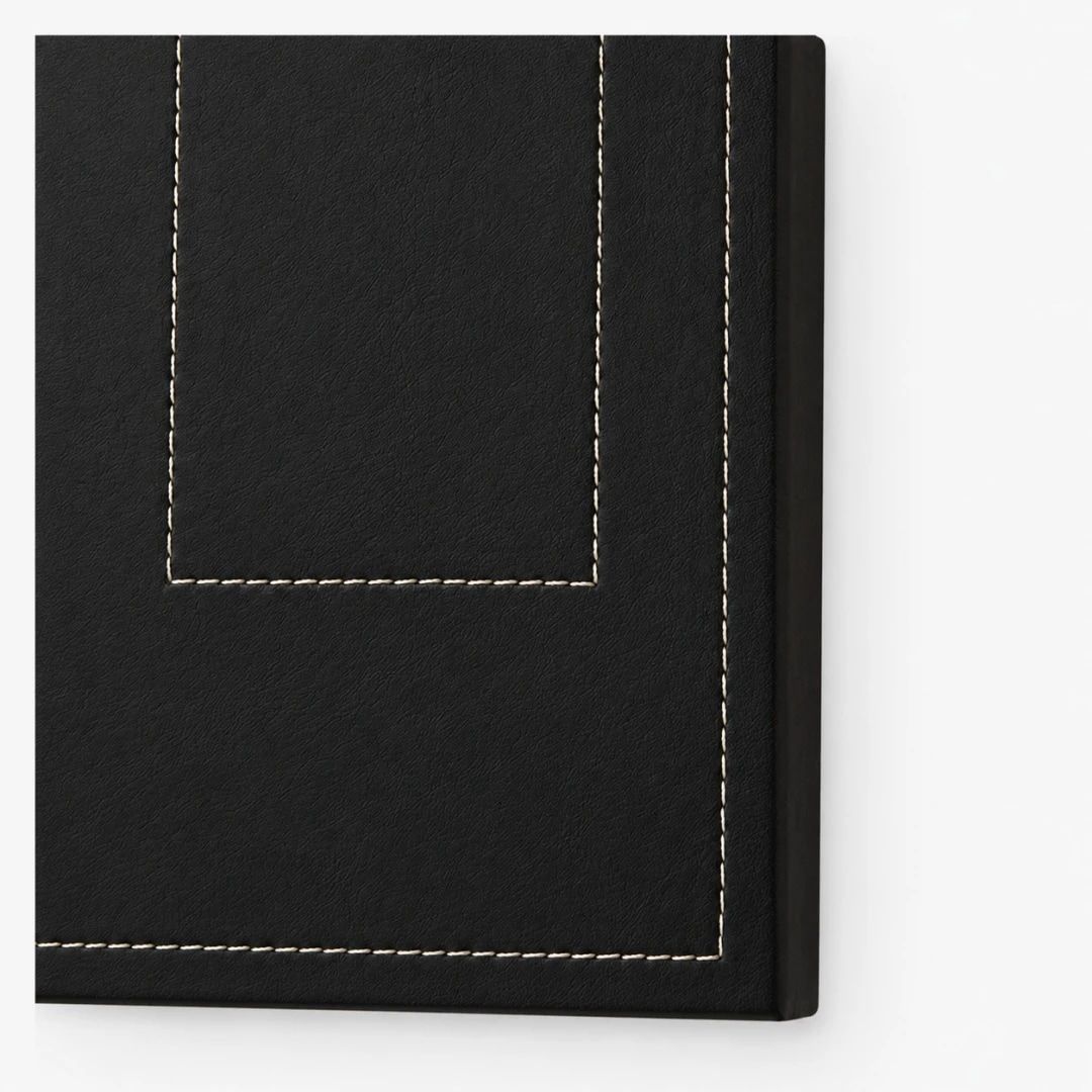 Close view of dark leather panel and contrast stitching