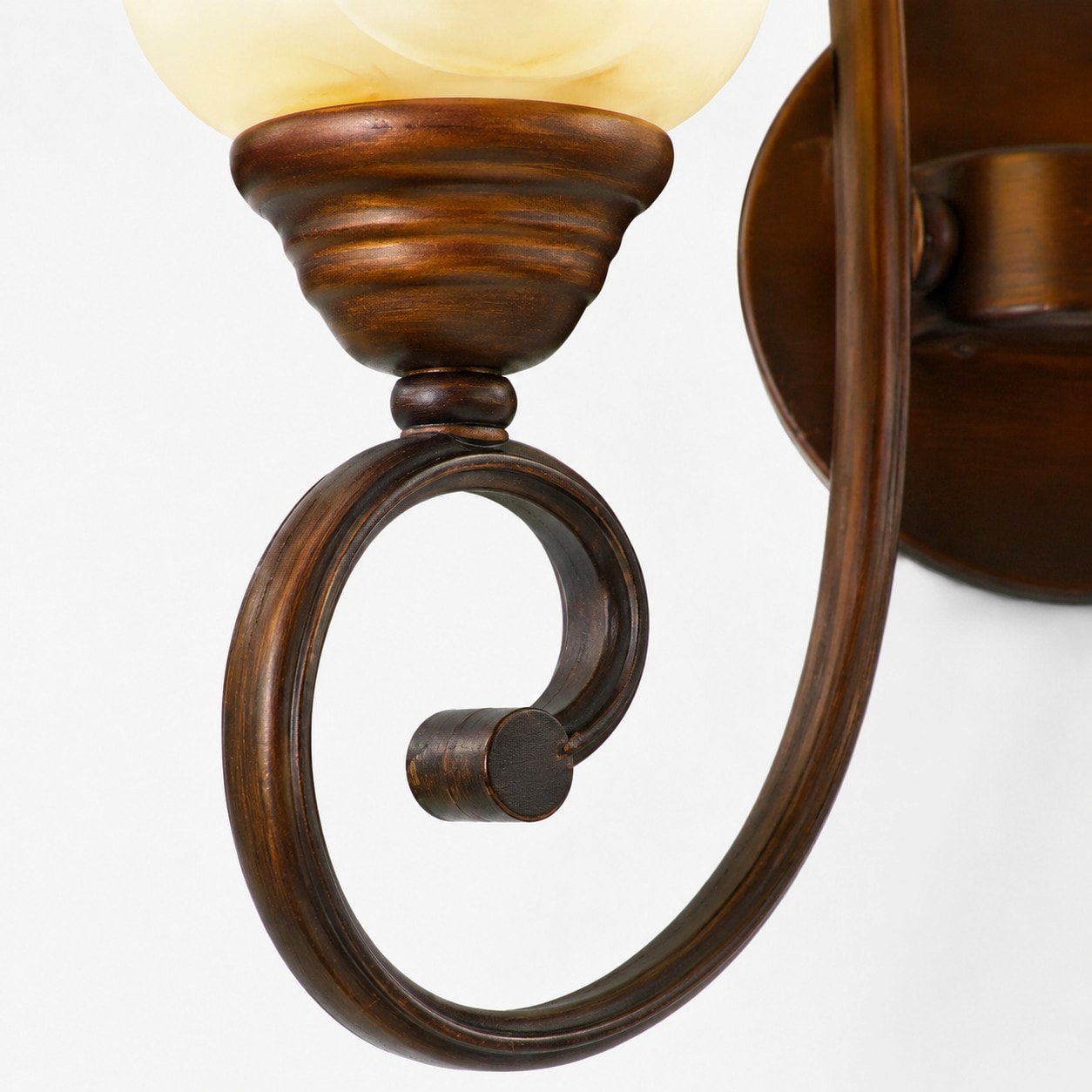 Curved scroll arm with bronze-tone finish