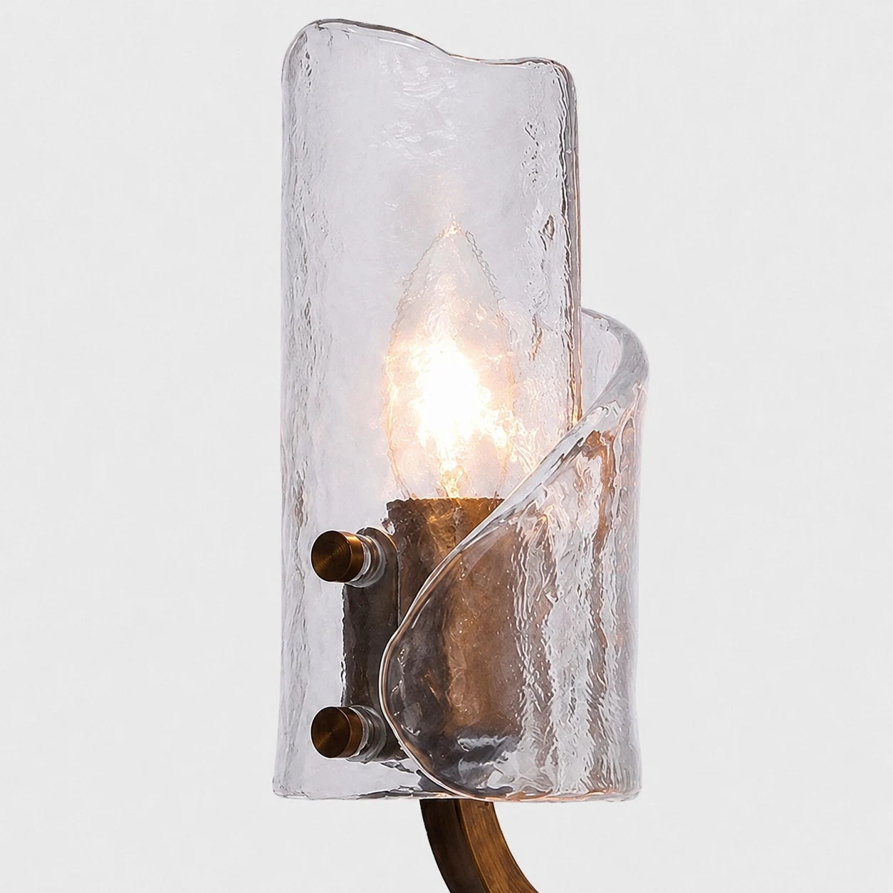 Brass body, rounded support and textured glass shade.