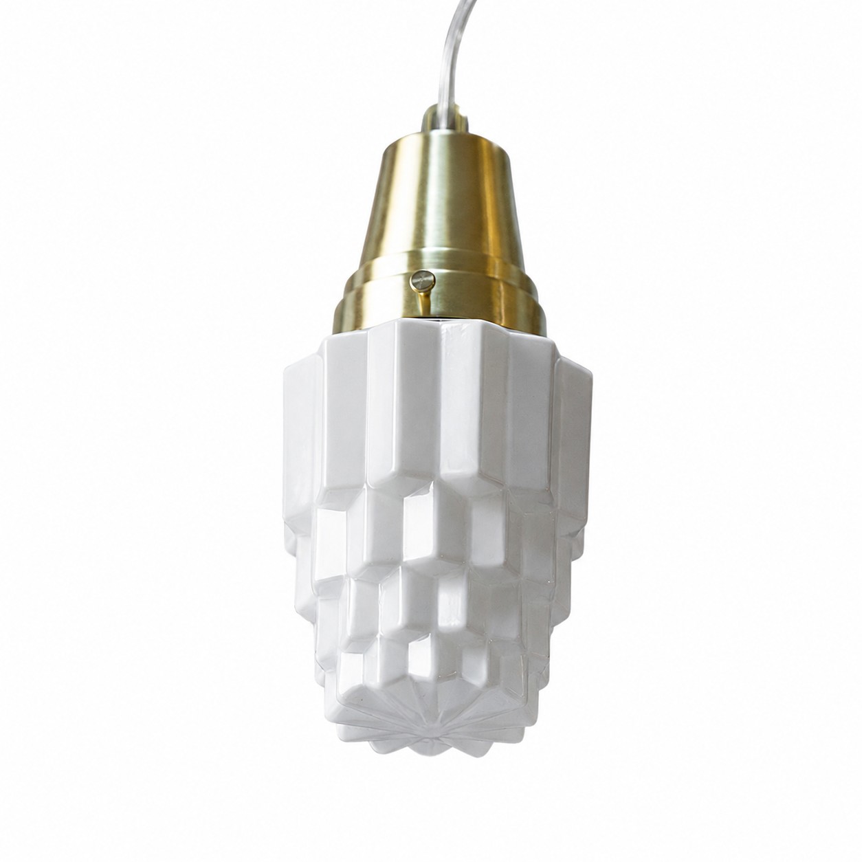 Brass top detail on milk glass pendant light