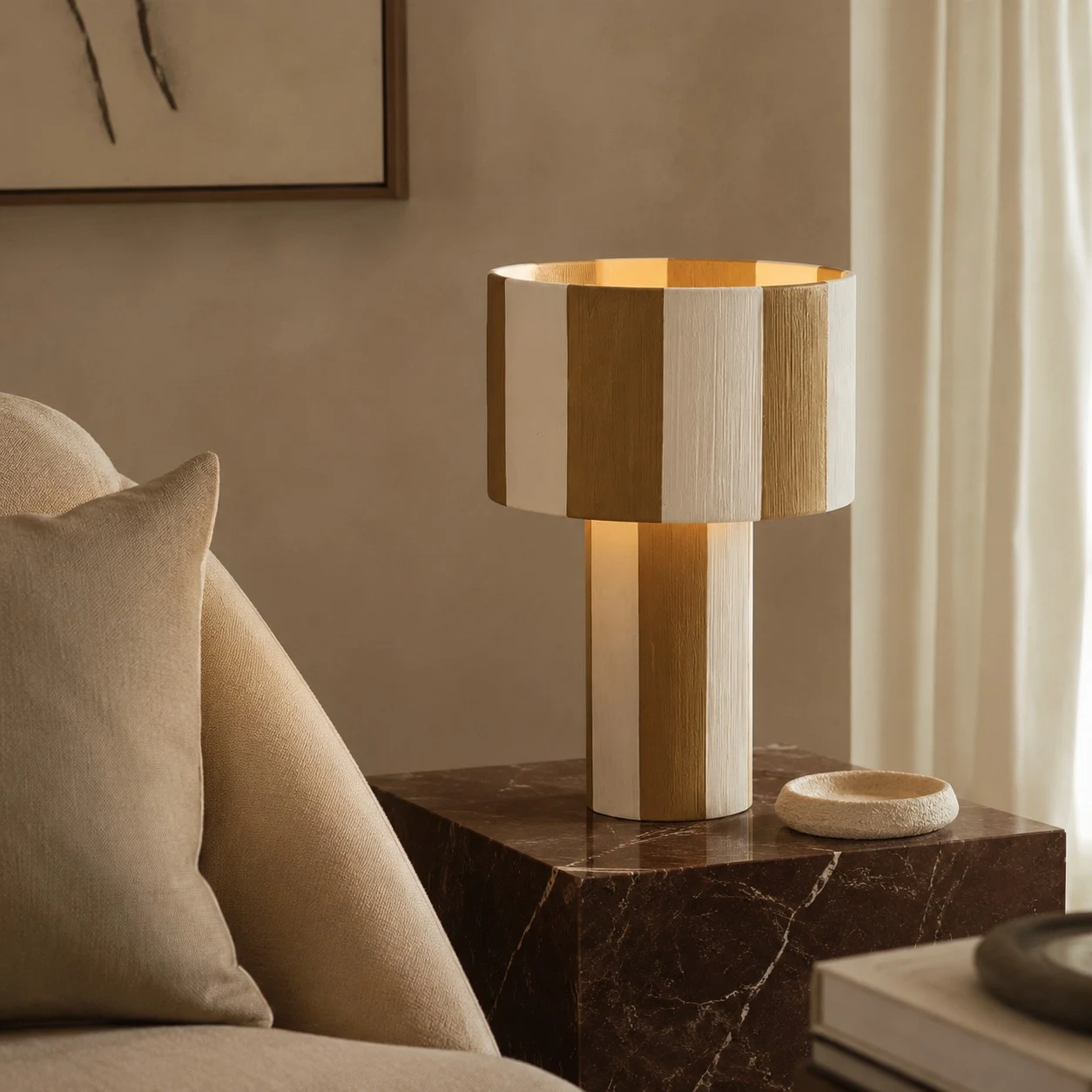 Striped woven table lamp lit beside a sofa