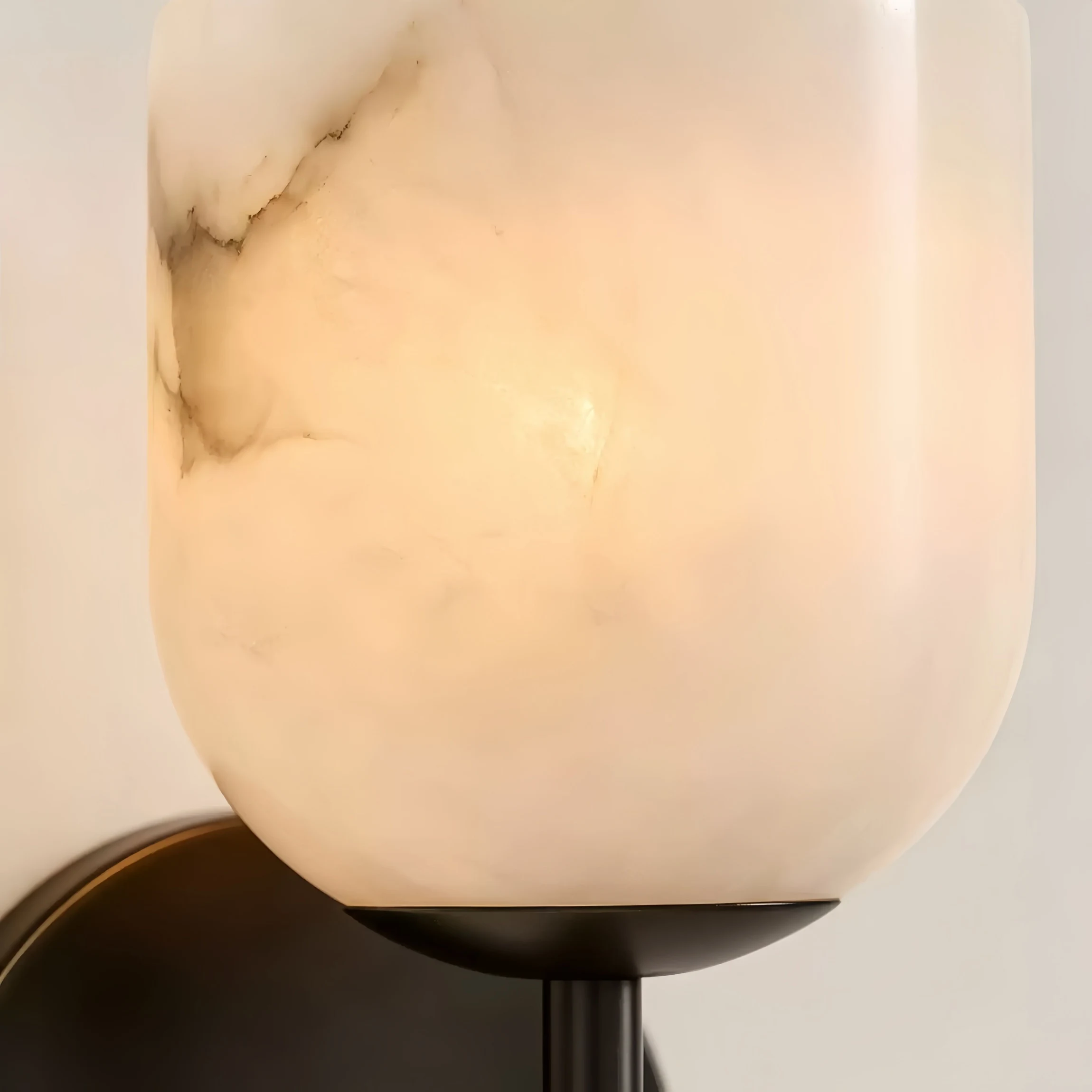 Close detail of white marble stone shade and warm glow