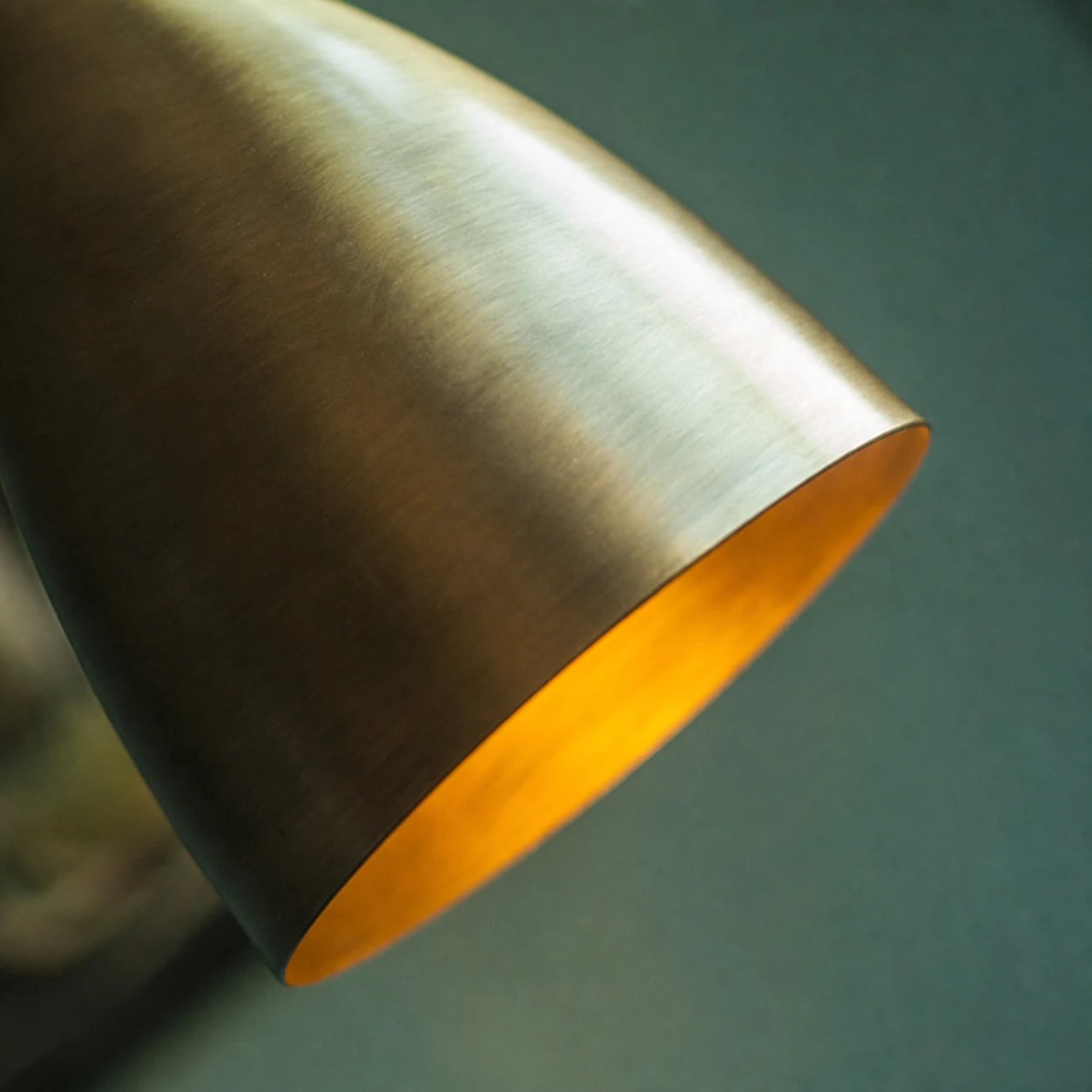 Brushed aged brass cone shade texture and warm interior