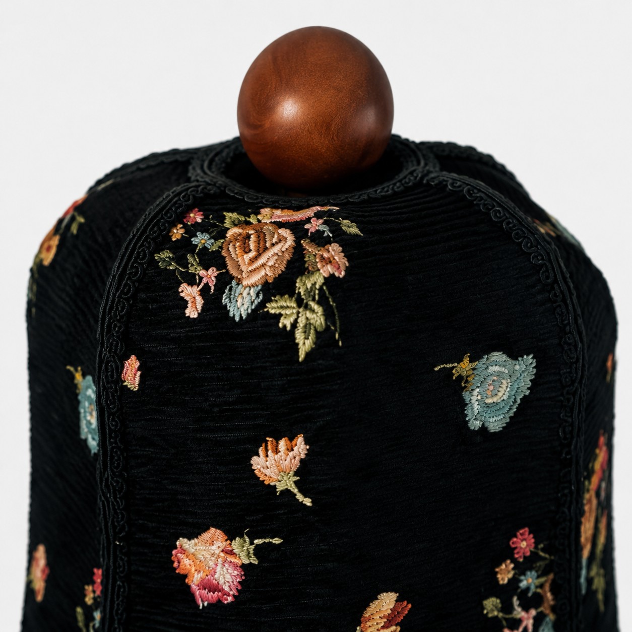 Floral fabric shade top and wood finial detail