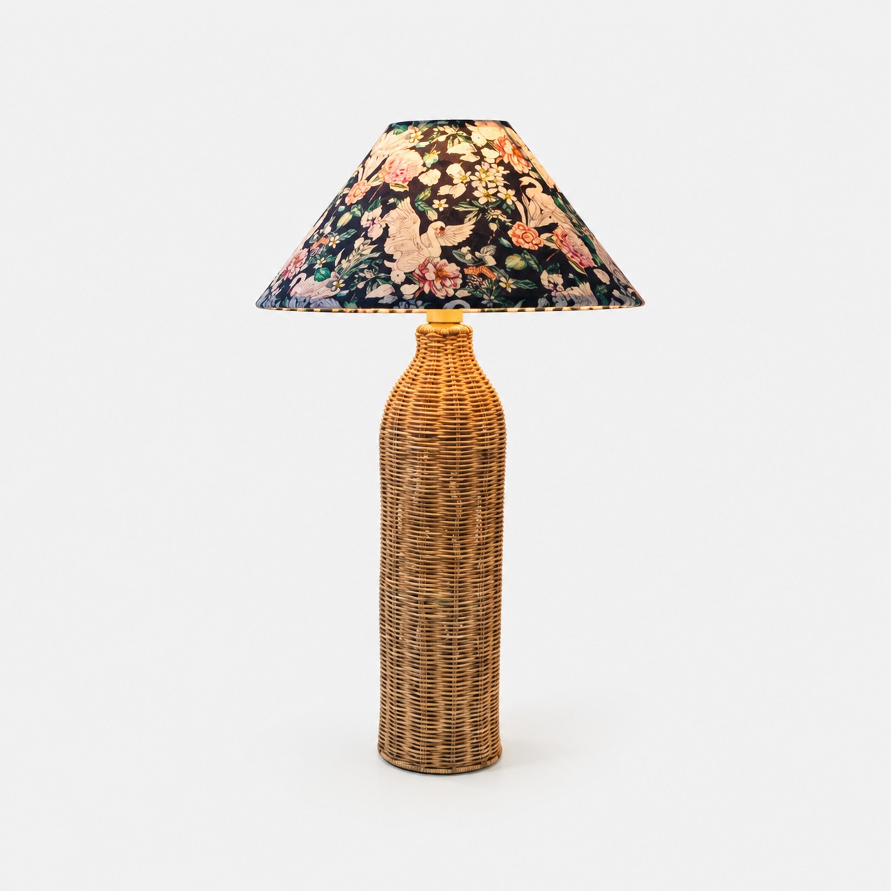 Woven rattan table lamp with botanical bird fabric shade