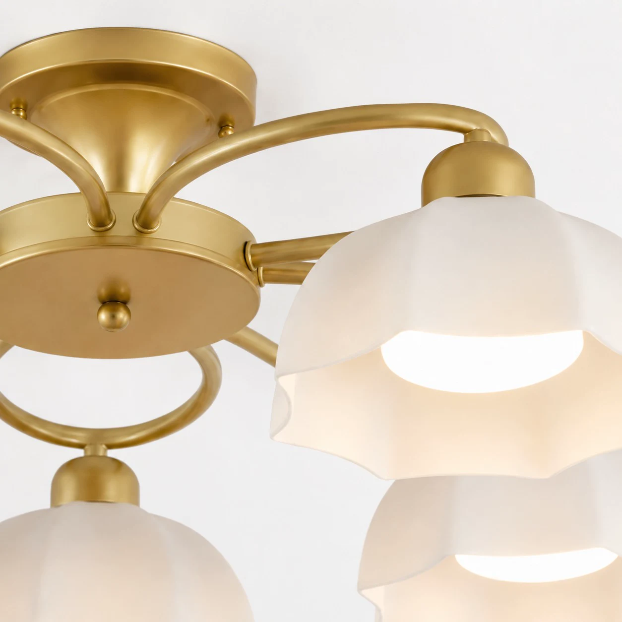 Brass-tone frame and white glass shade detail
