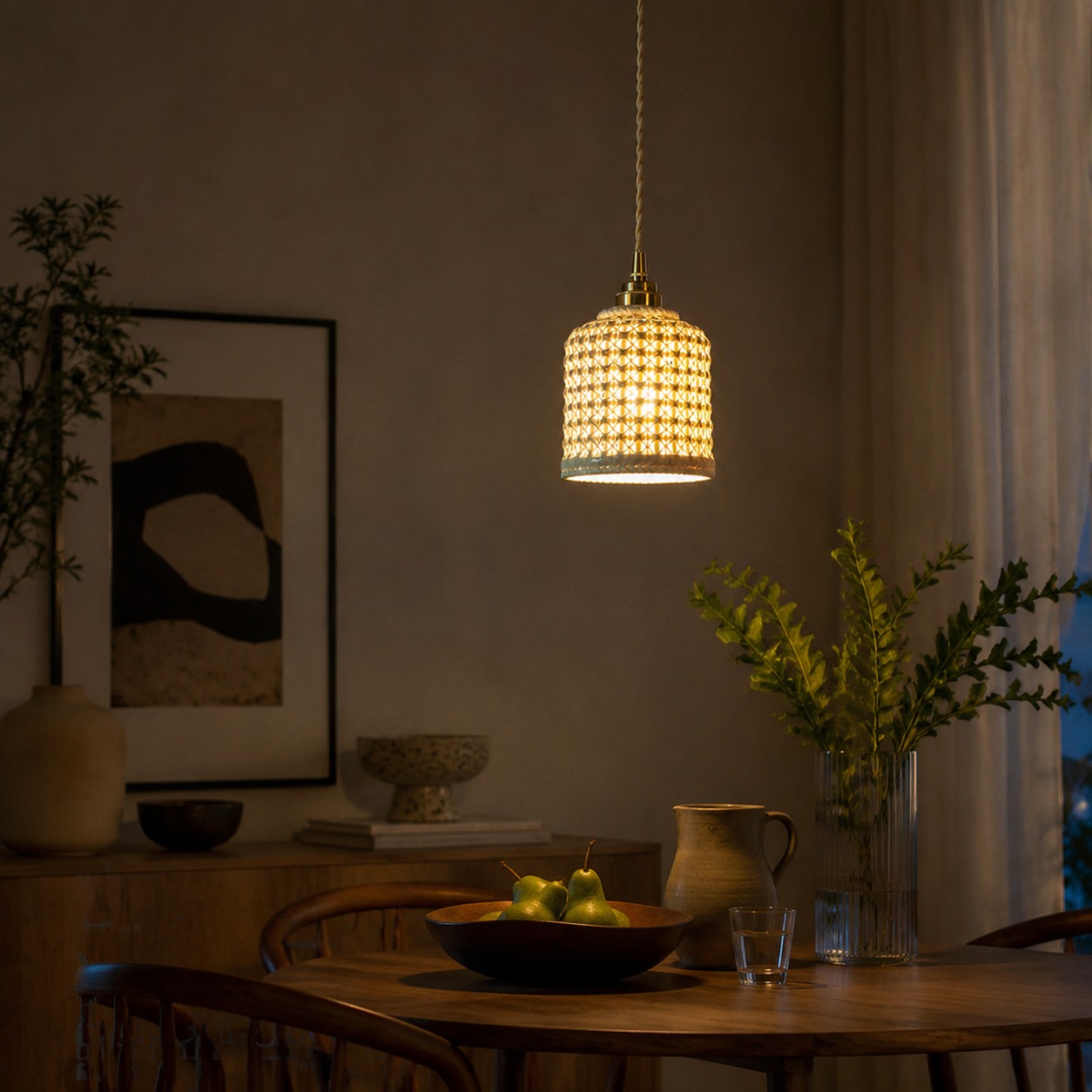 Handwoven ceramic pendant light above a dining table