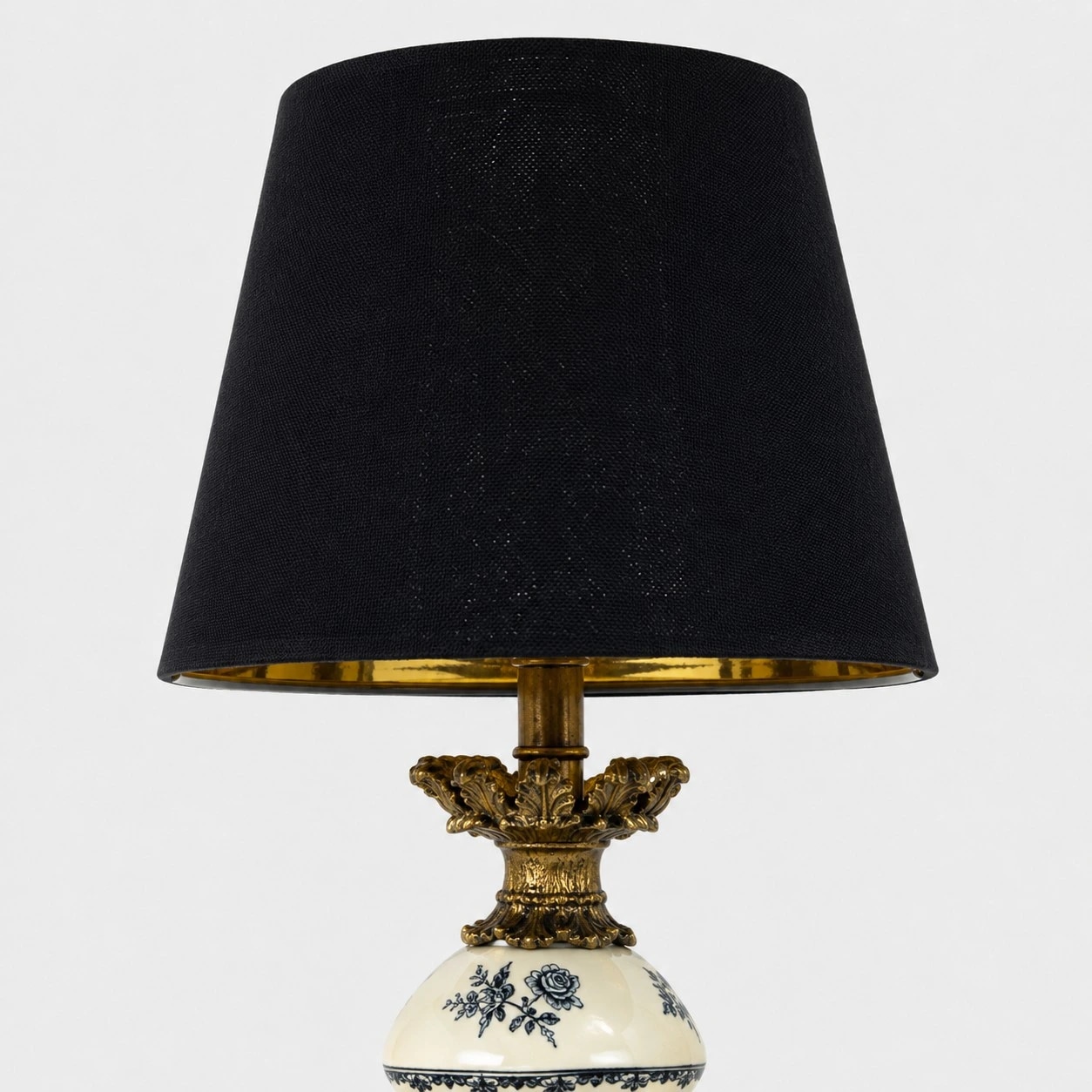 Black fabric shade with a warm brass-tone inner rim