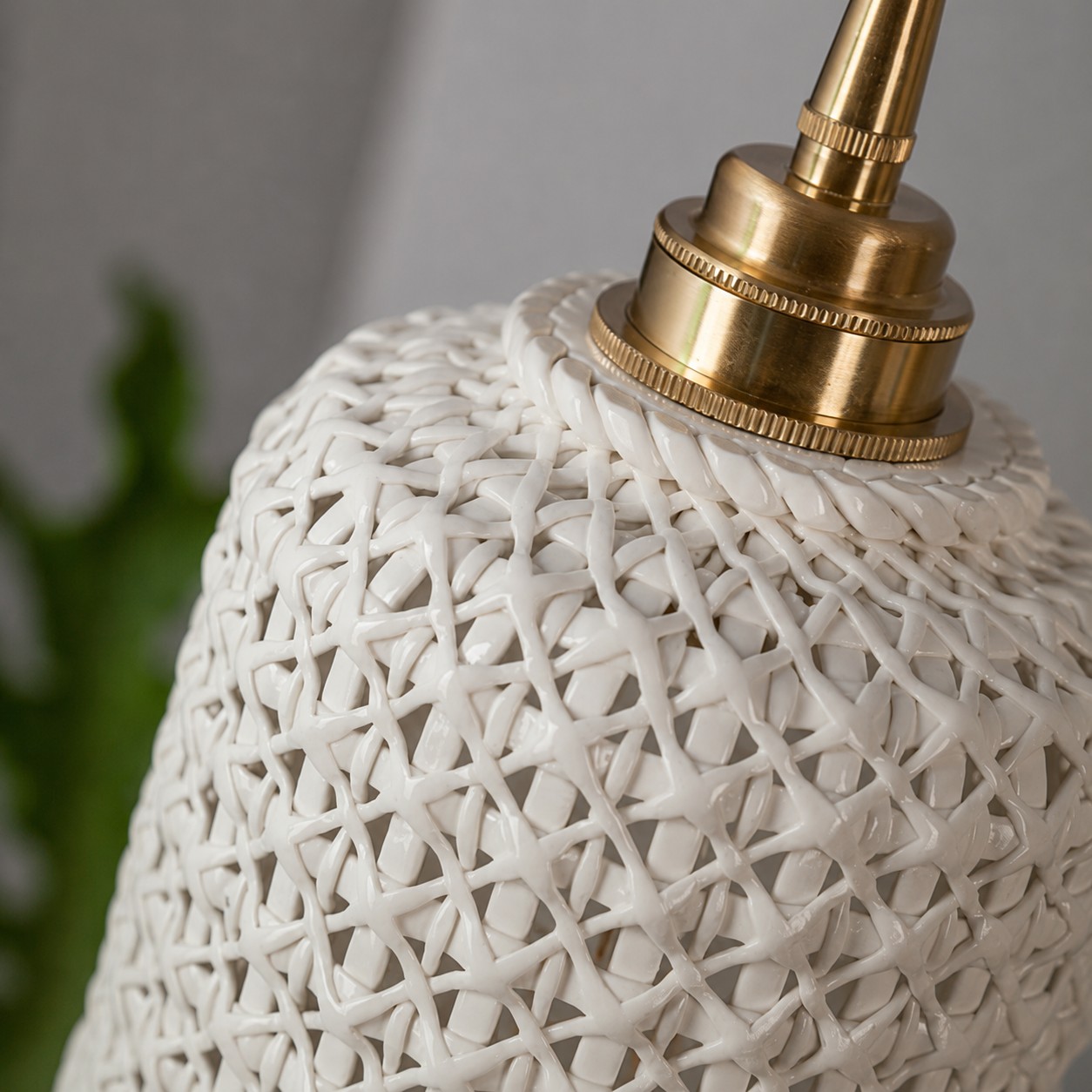 Brass-tone socket and ceramic shade detail