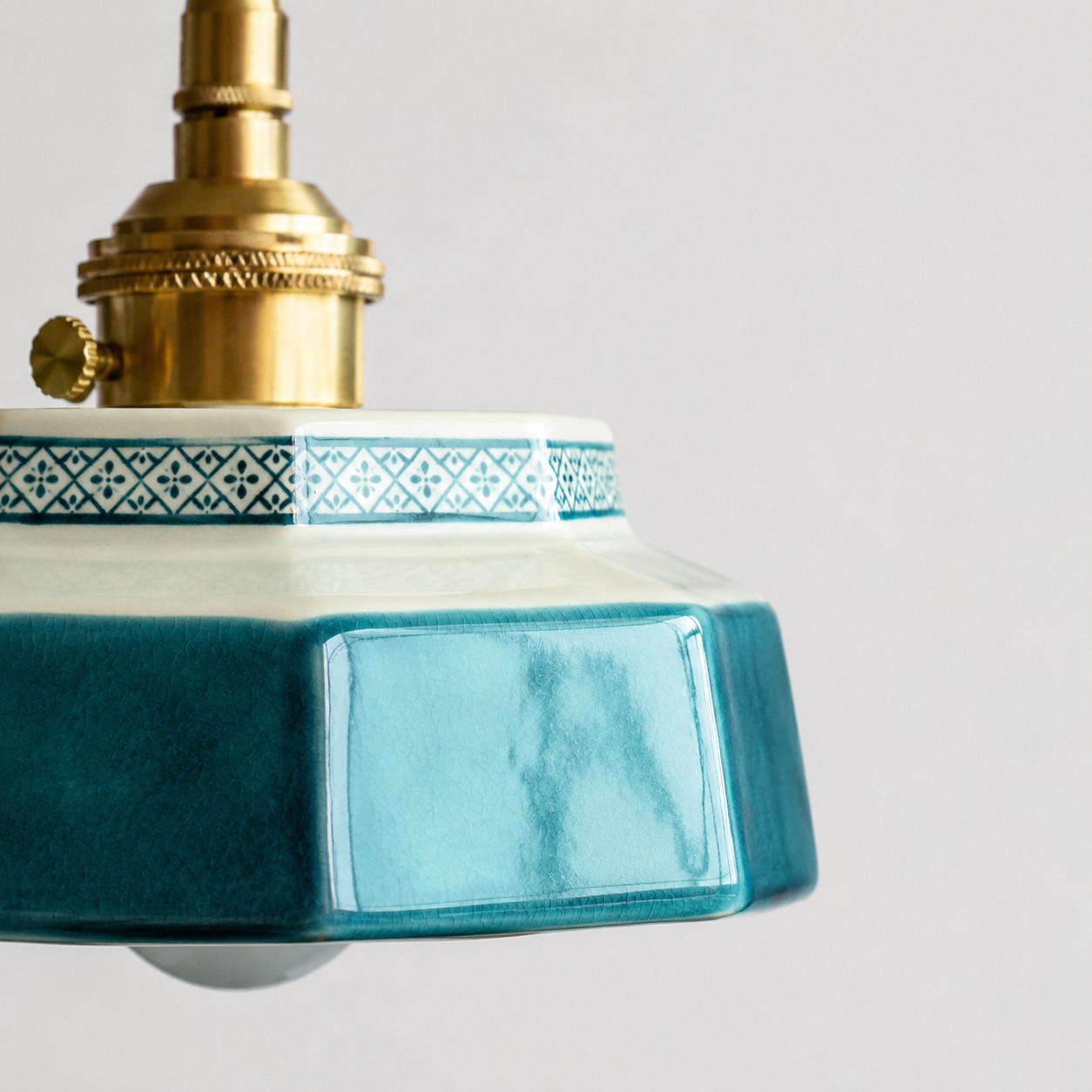 Ceramic shade edge and brass hardware detail