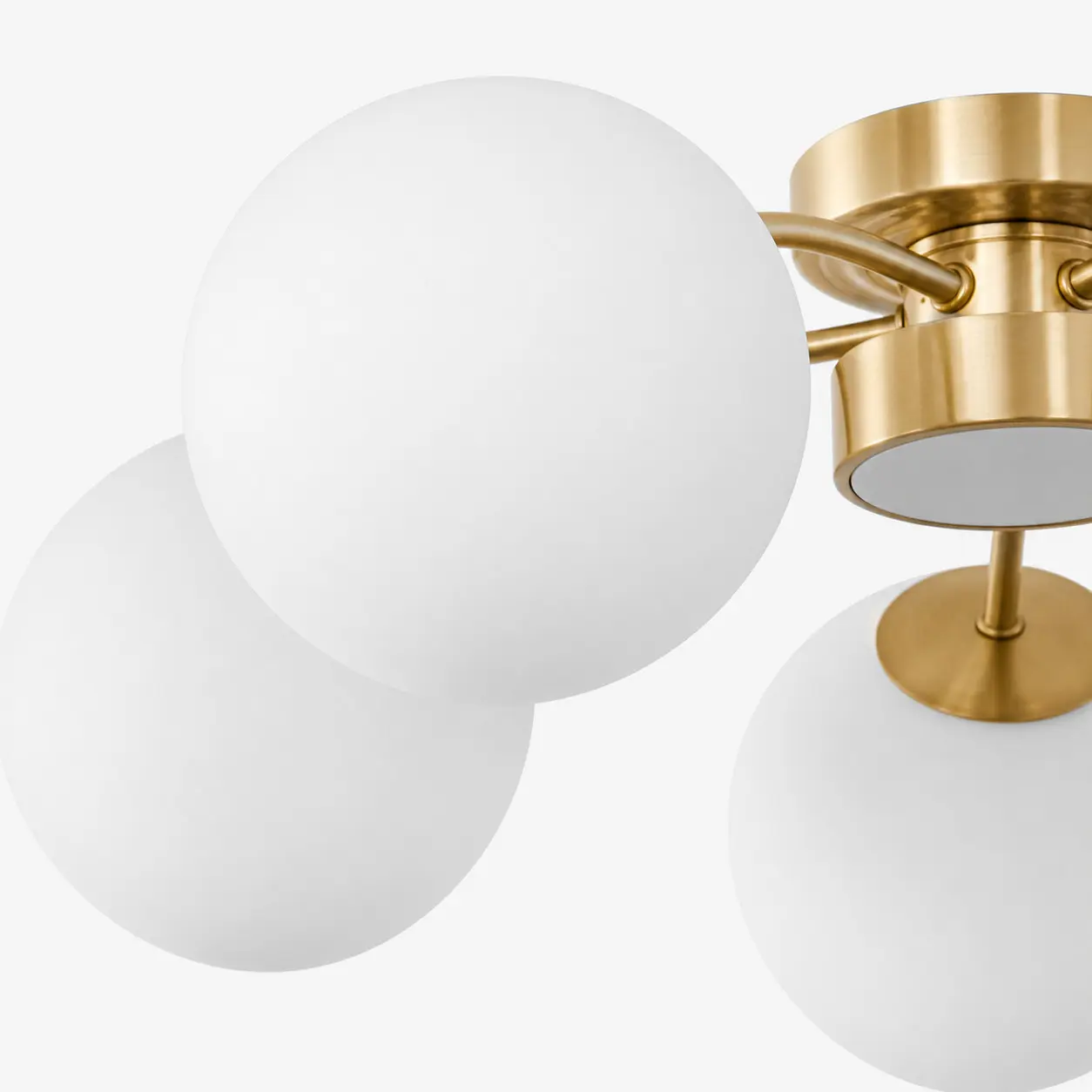 Close-up of frosted glass globe and brass arm