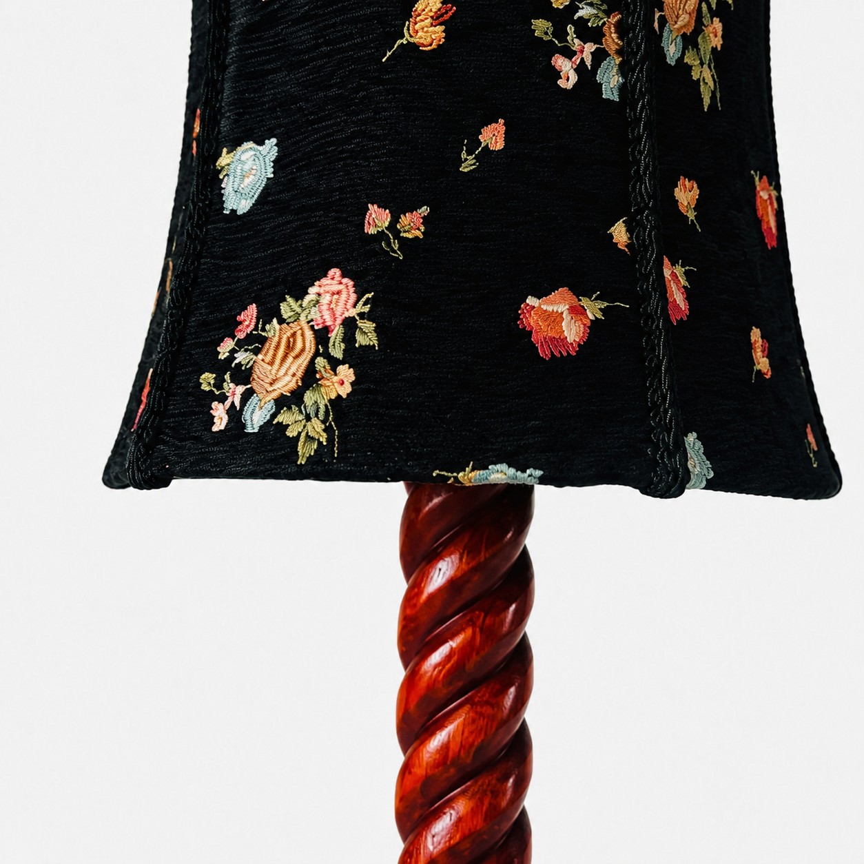 Floral fabric shade and sculpted wood detail