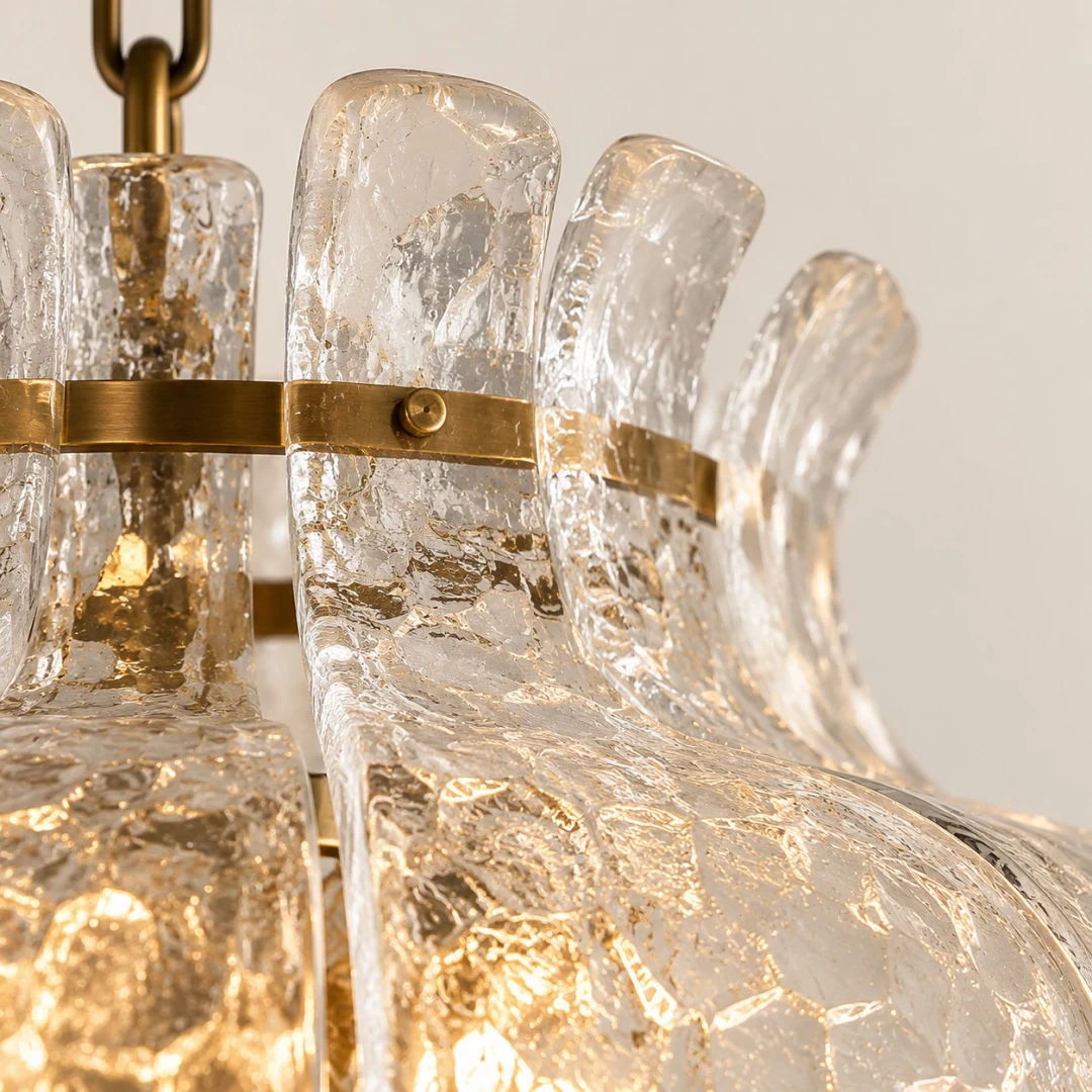 Abat-jour en verre transparent superposé autour d'une structure de lustre en laiton