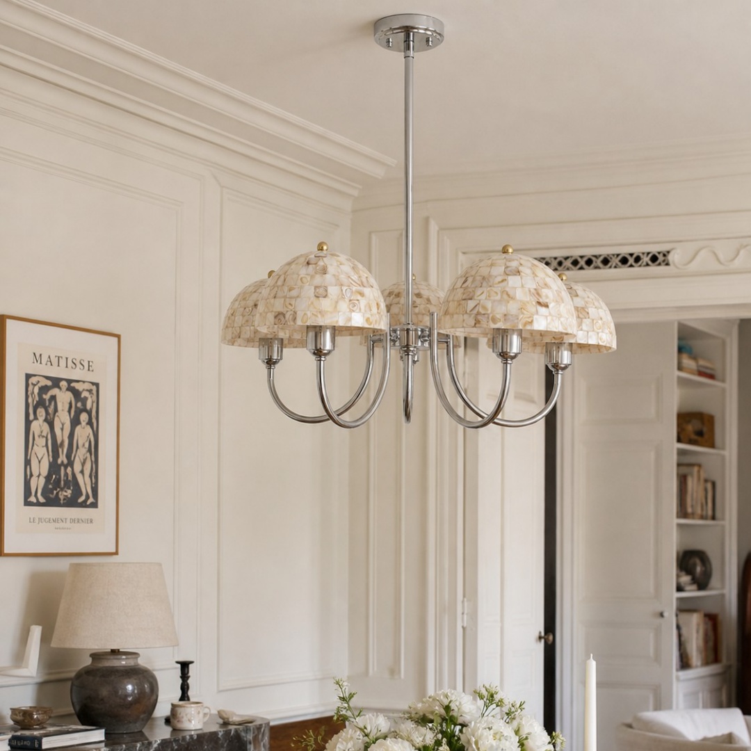 Lámpara de araña de cinco luces color beige con forma de concha instalada en un elegante comedor.