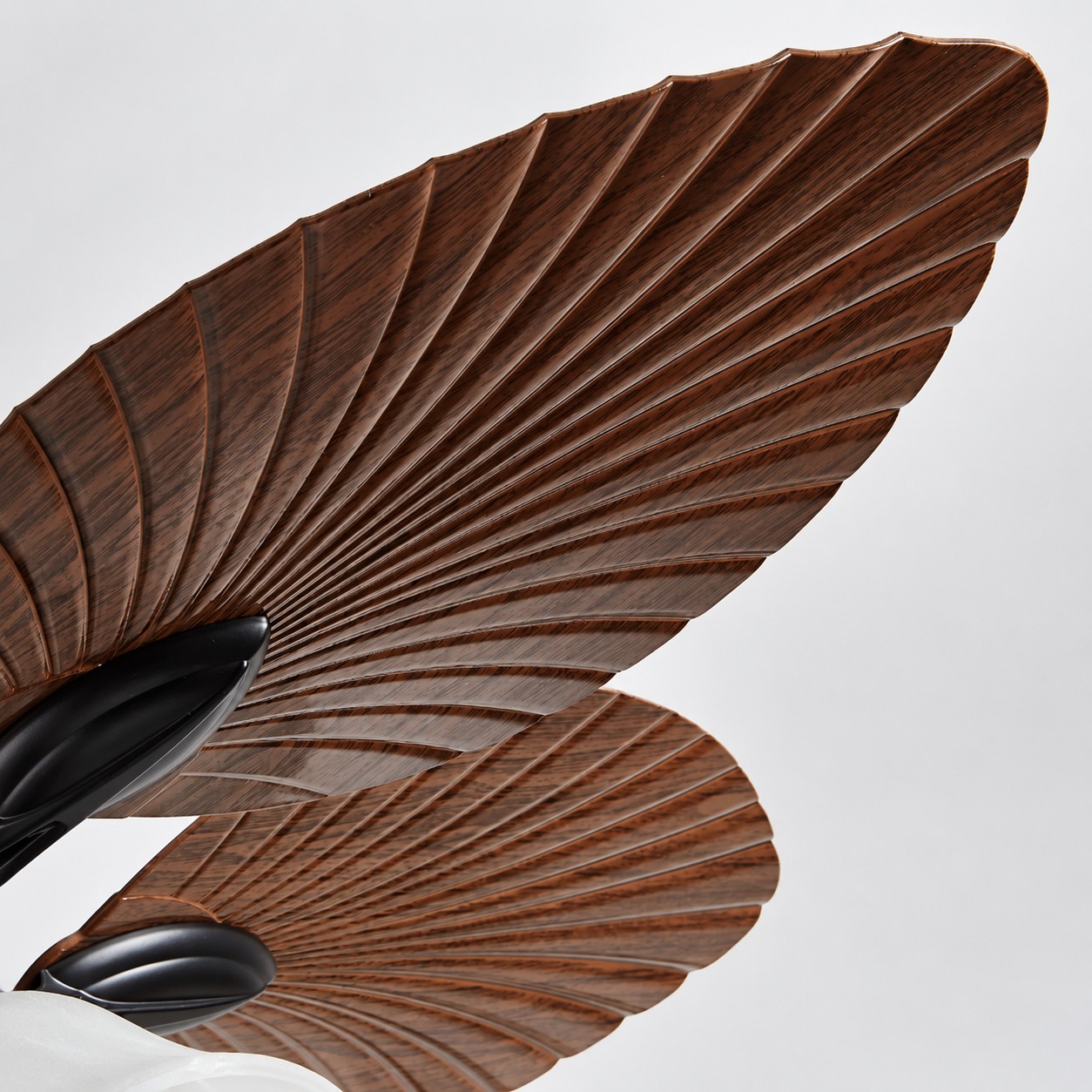Leaf-carved blades bring natural artistry overhead