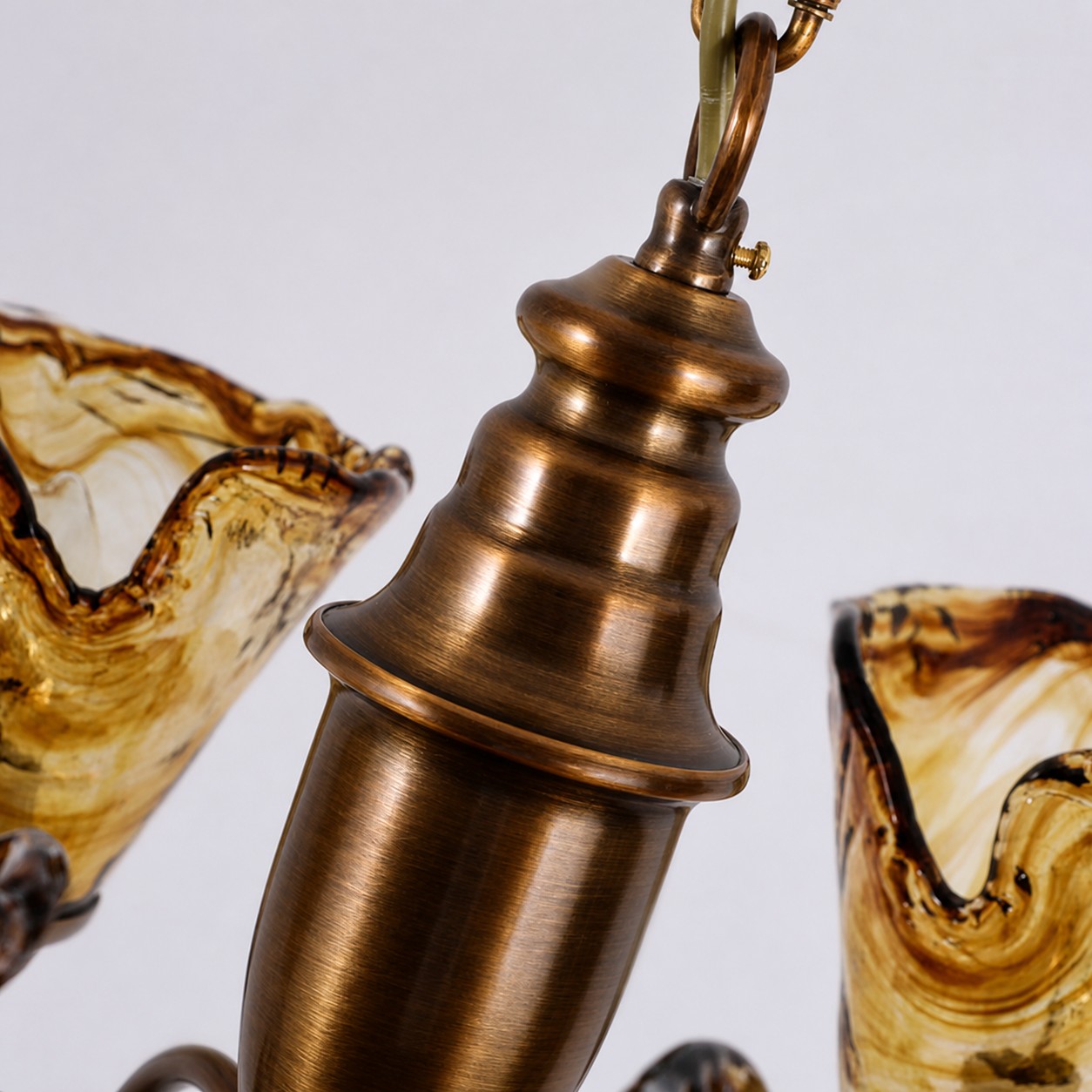 Sculpted antique brass chandelier stem