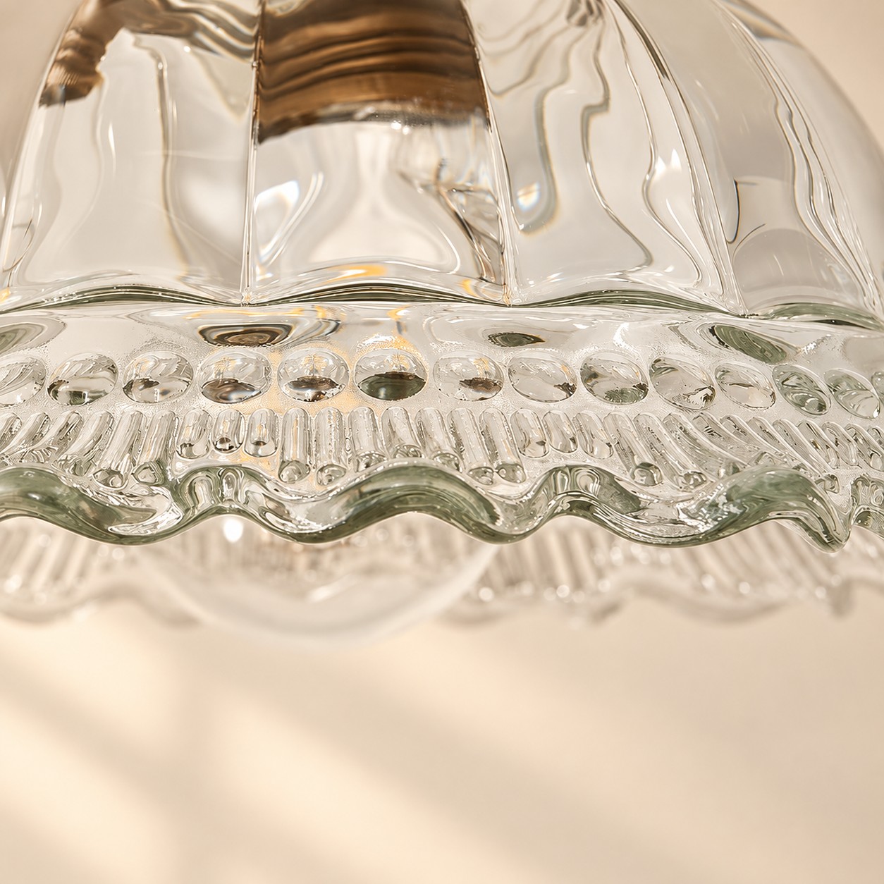Close-up of fluted glass with beaded band and scalloped rim